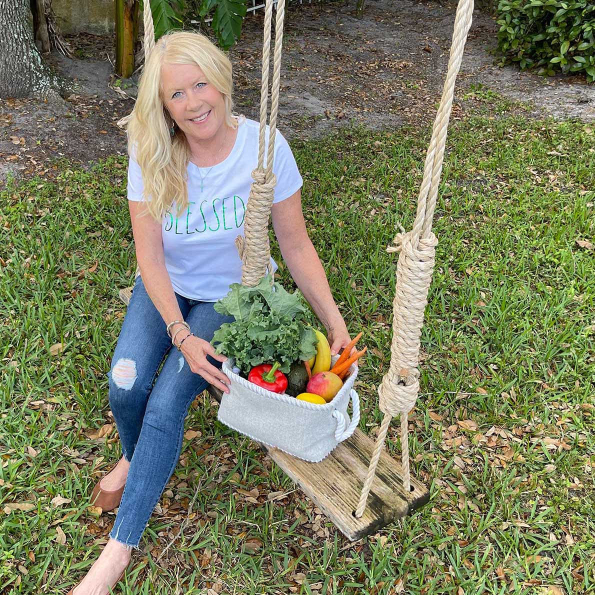 Diane powell sitting on a rope swing