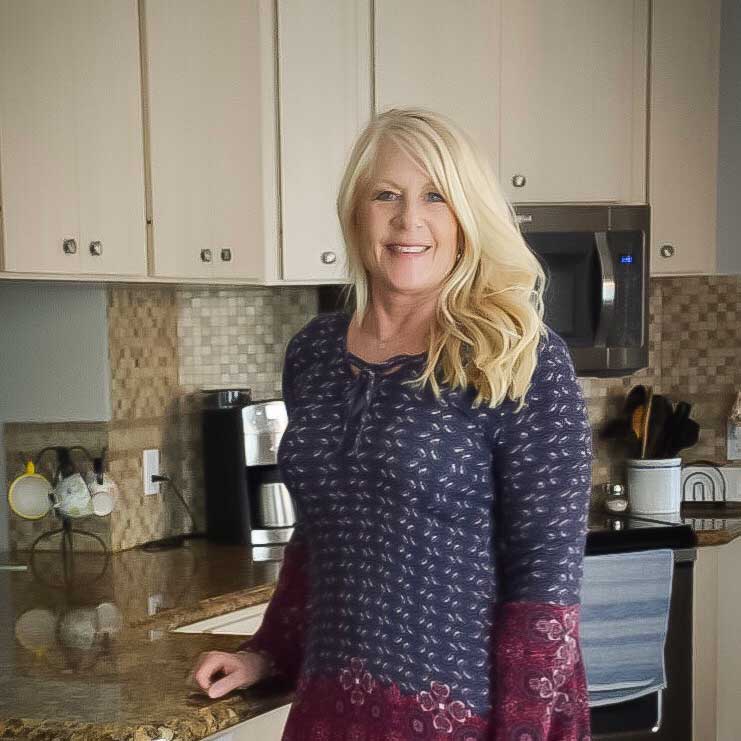 Diane powell standing in a kitchen