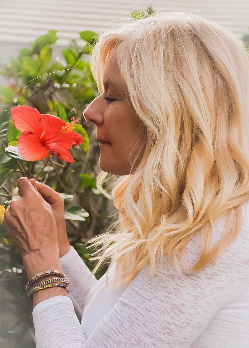 diane powell smelling a pink hibiscus