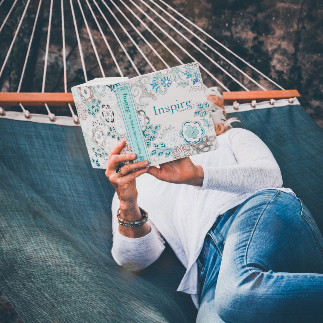diane powell reading a book on a hammock