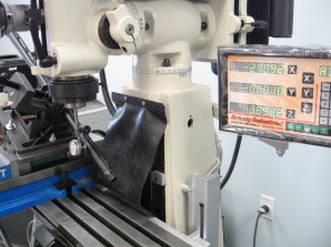 A mill being used to open ports in the barrel of a gun