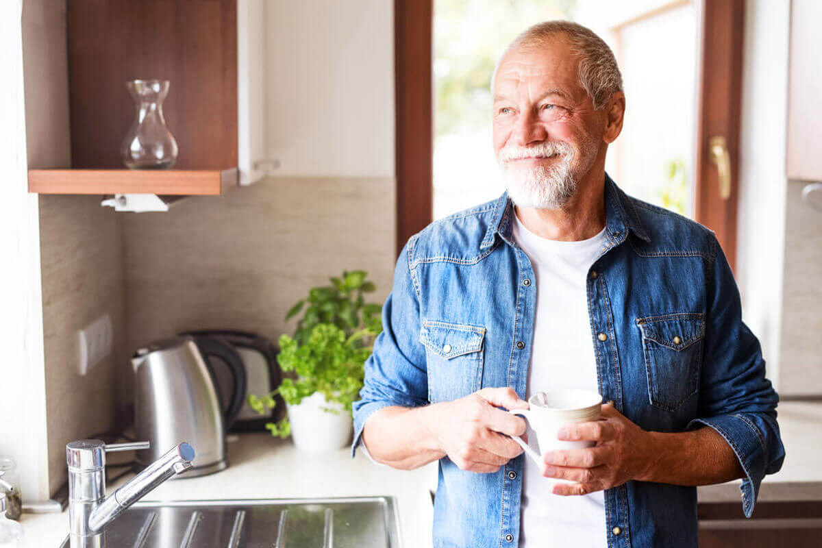 Man in kitchen with cup