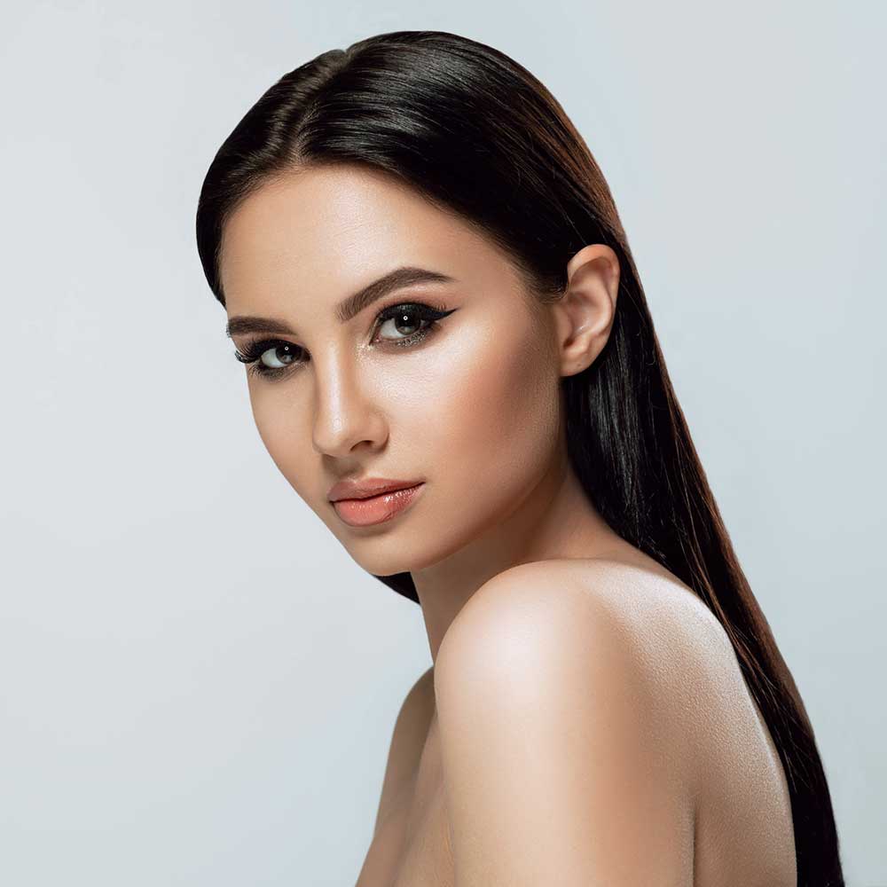 beautiful woman with dark hair and glowing skin