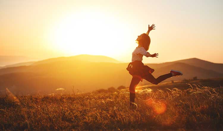 woman jumping in the sunset