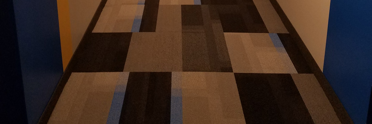 Non-patterned Carpet Tile in an apartment building hallway