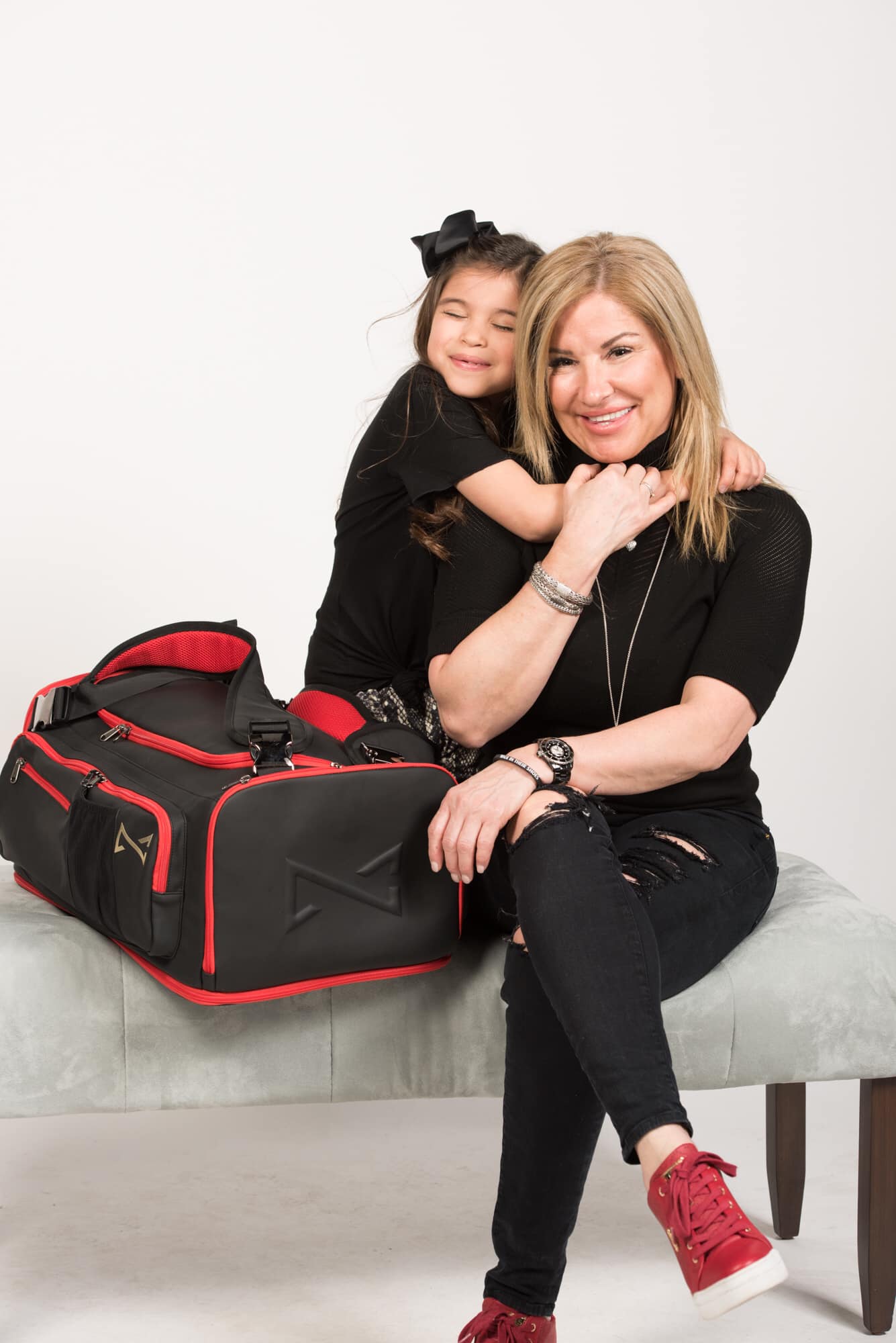 Natalie Craig with a WITS donation bag and little girl