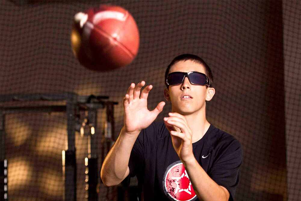 teen catching football at Athletic Republic