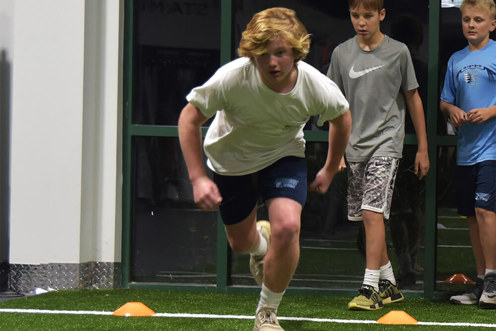 boy doing running drill at athletic republic