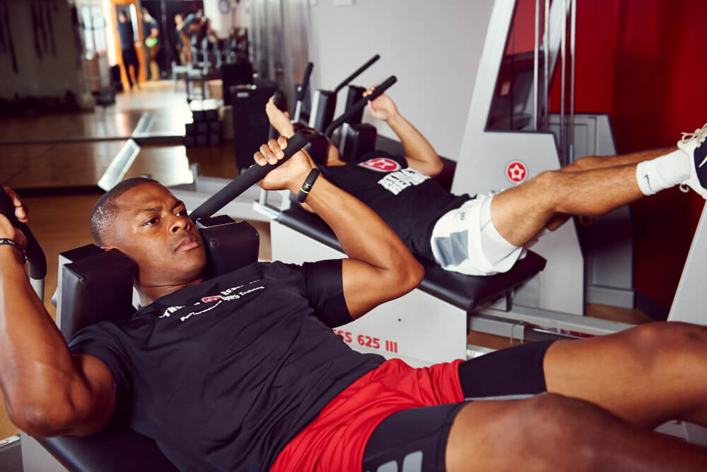 two men doing arm workout at athletic republic
