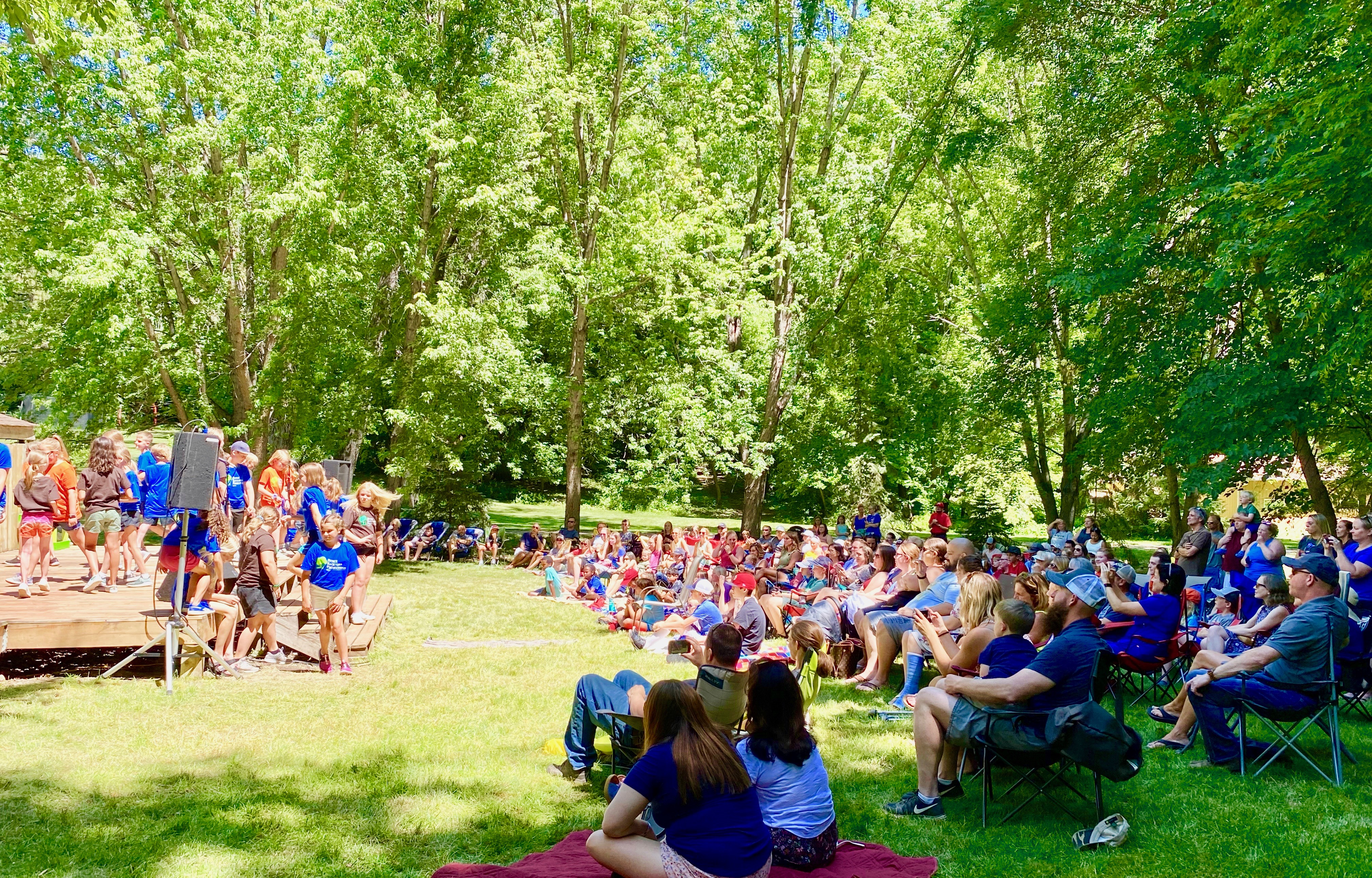 Maple Grove elementary theater camp performance of Annie with backyard crowd