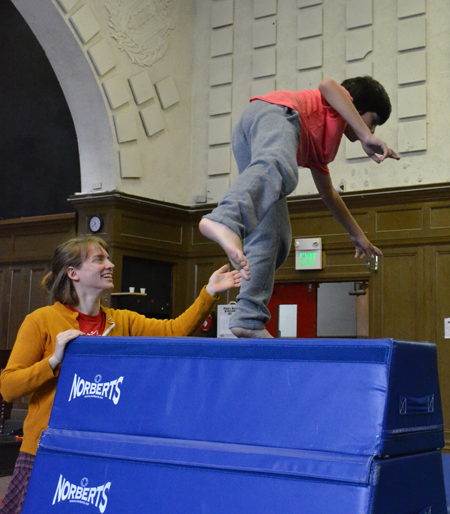 Teacher helps young student through jumping exercise | Circus Center | San Francisco