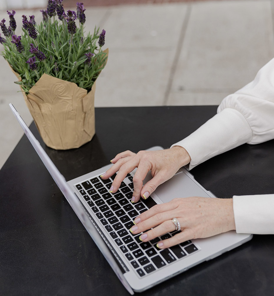 health coach colleen hammann typing on laptop