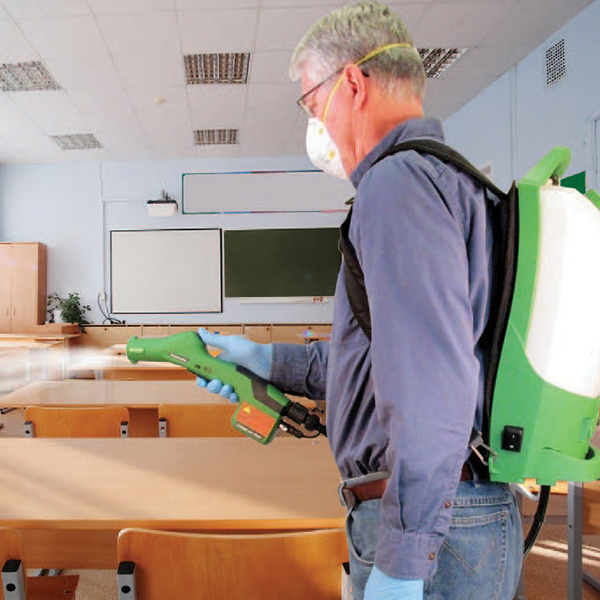 A worker cleans the classroom from Coronavirus and other outbreaks with an electrostatic sprayer.
