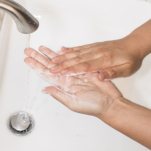 Person washing their hands to protect themselves from infectious outbreaks and Coronavirus.