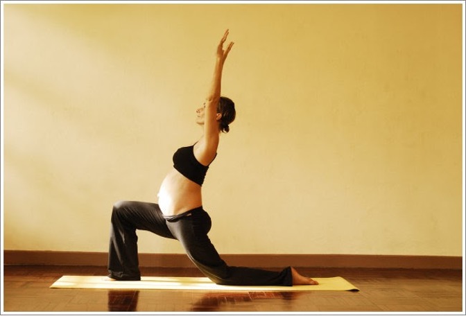 pregnant woman doing a lunge yoga pose at cocoon care