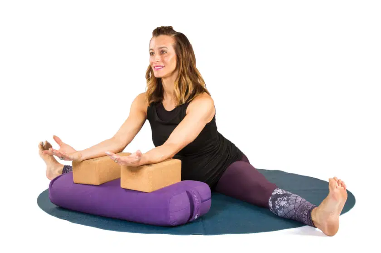 woman doing a seated strattle yoga position at cocoon care
