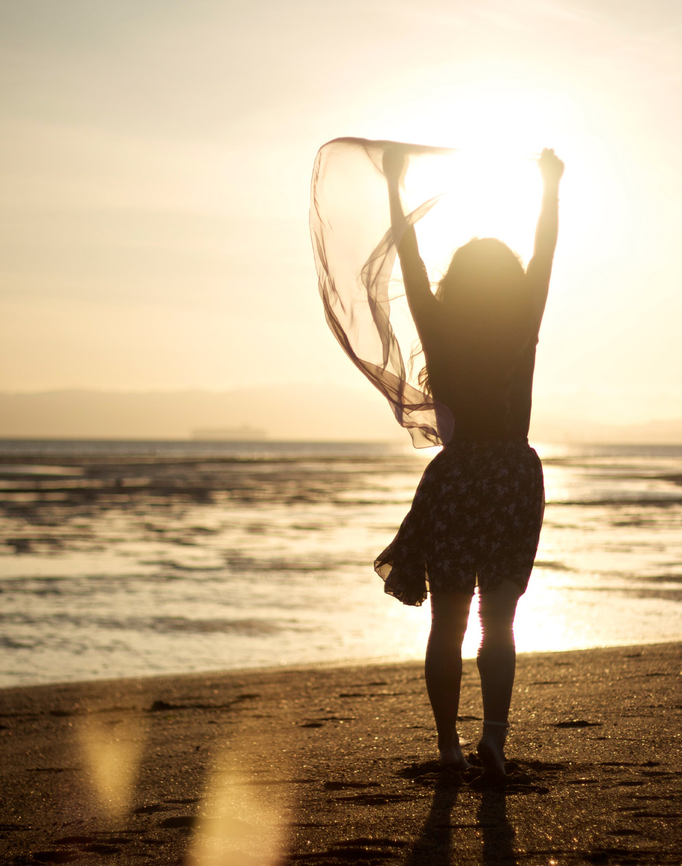 joyful woman standing on beach