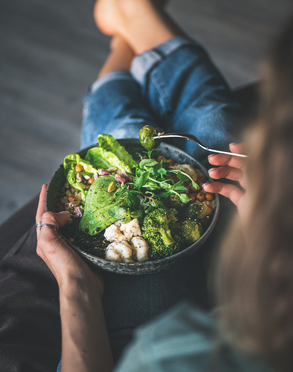 woman holding healthy bowl of food