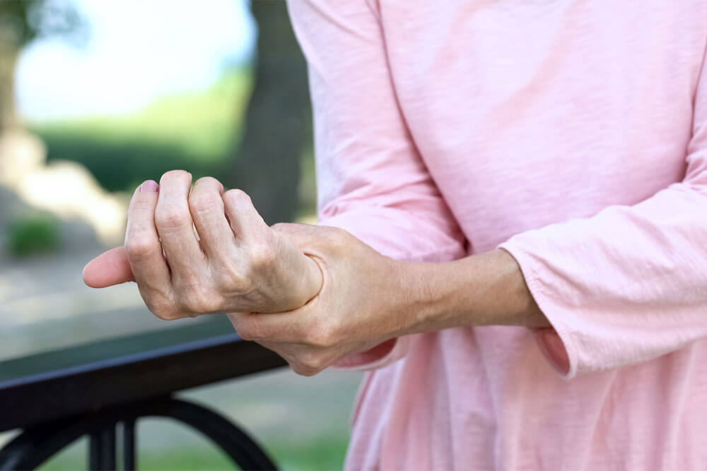 older-woman-holding-hurt-wrist