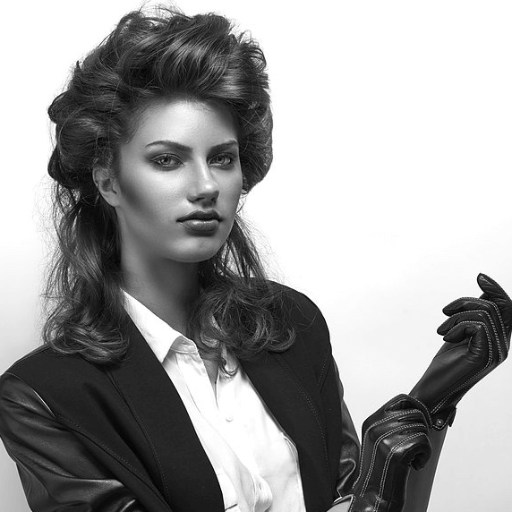 woman-in-blazer-putting-on-gloves
