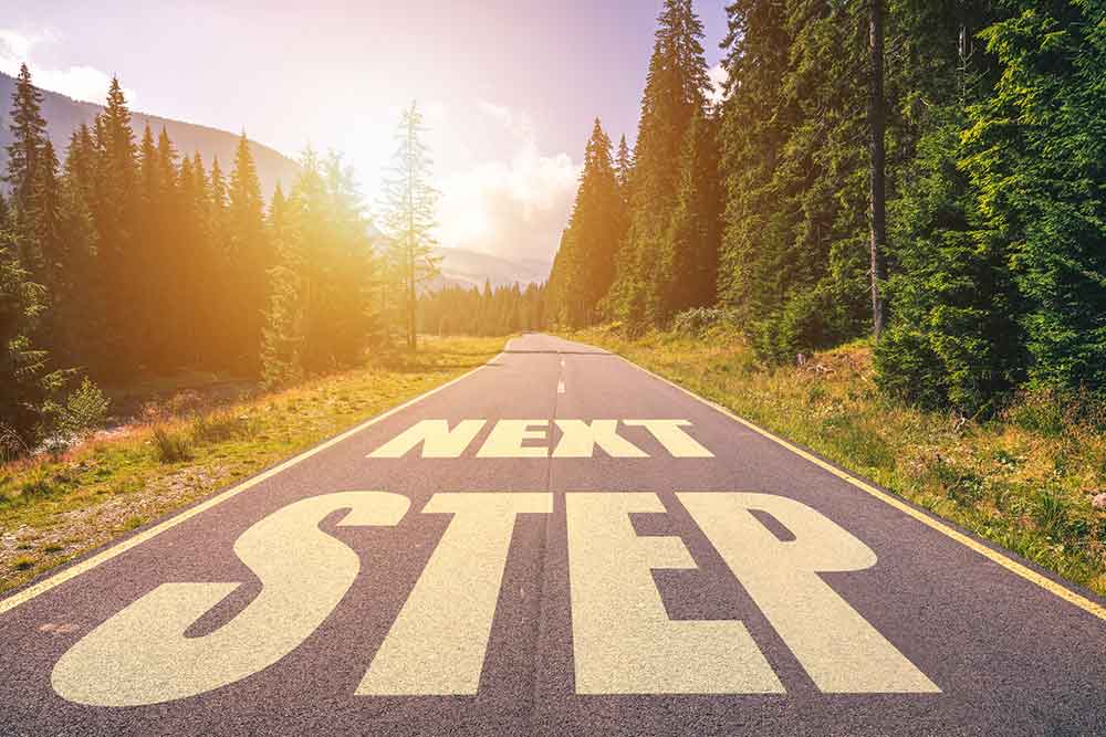 highway with the words next step on the road