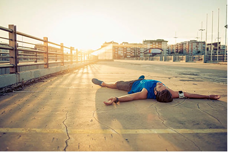 tired man laying down after a workout
