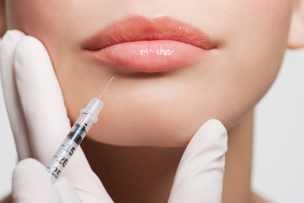 injecting needle into woman's lip