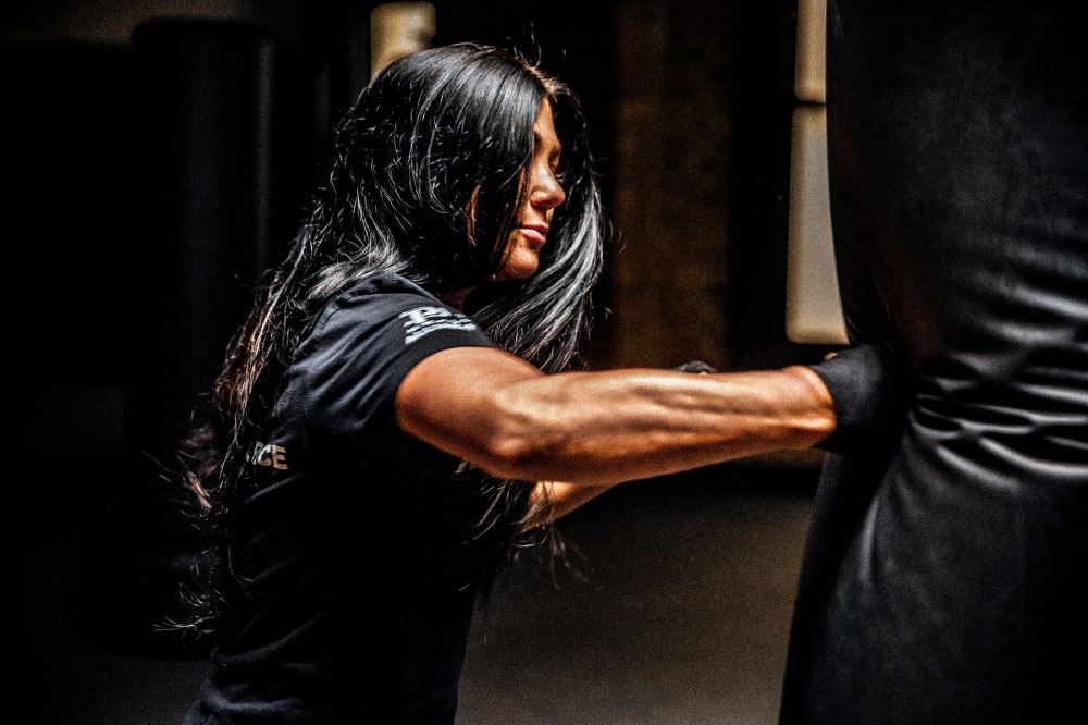 woman punching boxing bag