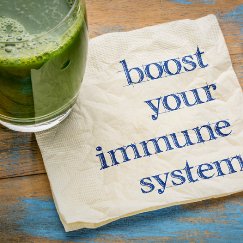 green smoothie sitting by a notepad stating boost your immune system