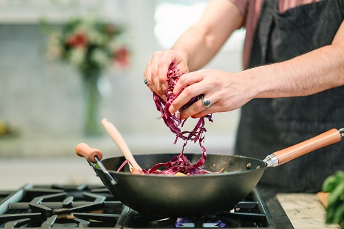 adult cooking cabbage in a pan - safe cooking - teflon cookware