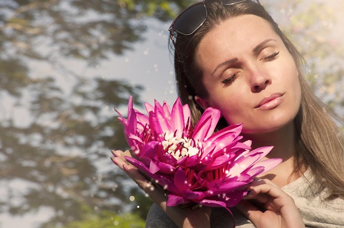 lady holding a pink flower
