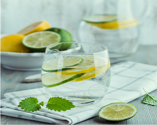 glass of water with lemon and lime slices