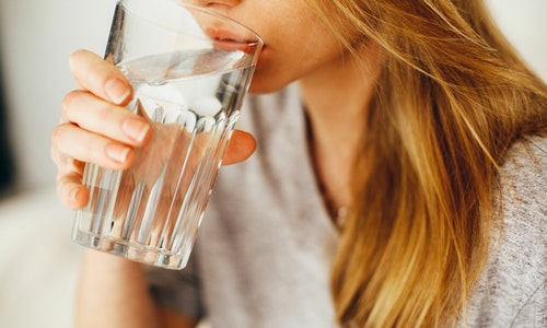 lady drinking a glass of water 