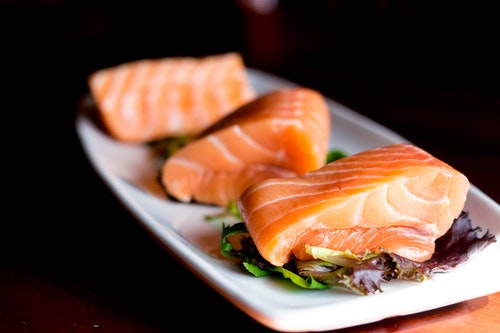 pieces of salmon on a plate- omega fats - healthy fats
