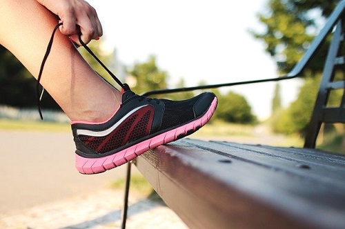 putting on running shoe - exercise