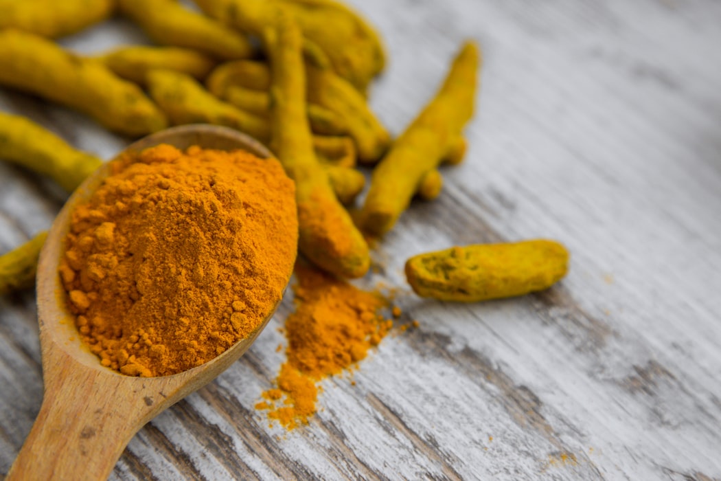 turmeric on a wooden spoon - natural spices