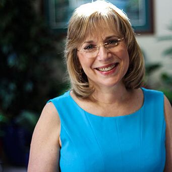 leora amir in a blue shirt