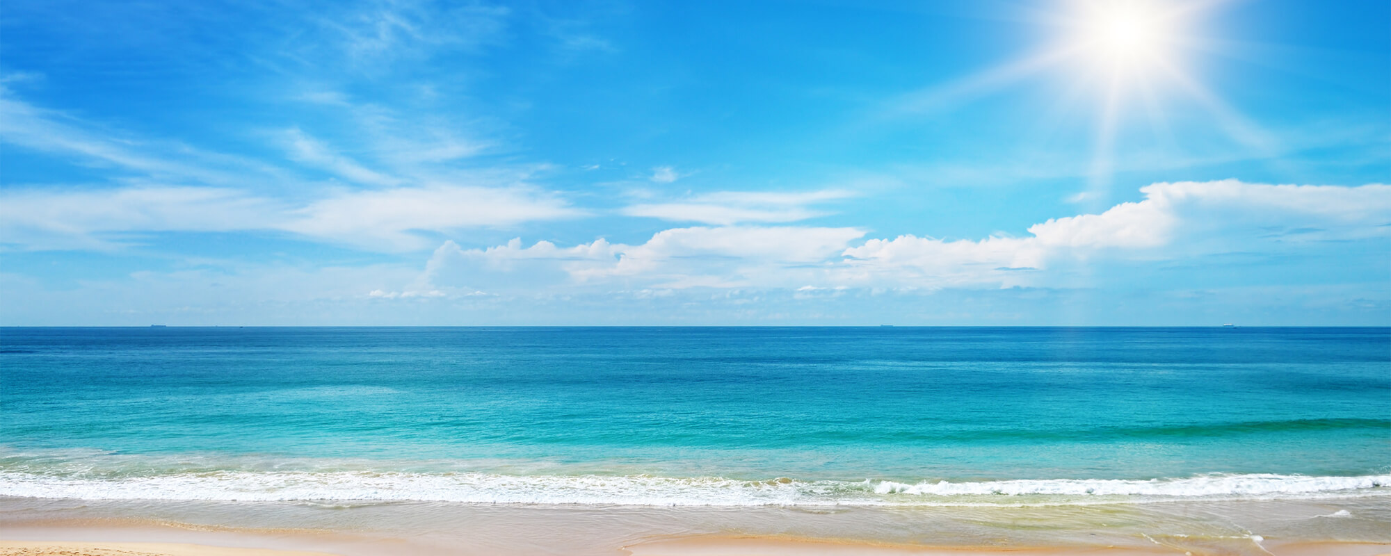 sunrise on a beach with blue sky