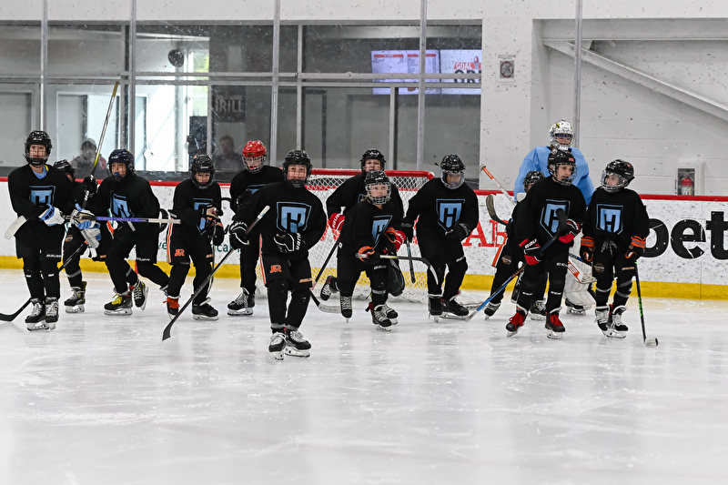 three men playing hockey
