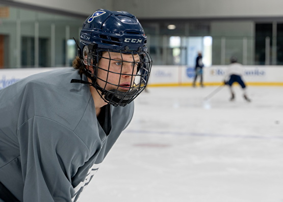 line of hockey players with a cone