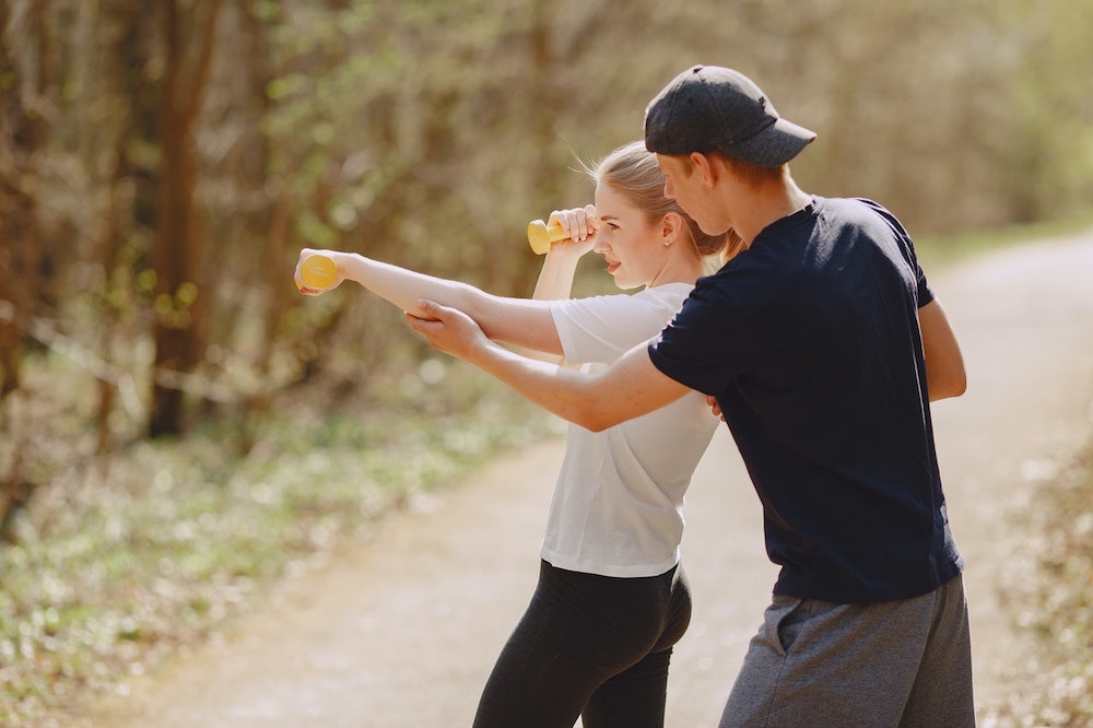 determine-couple-in-sportswear-during-workout-in-park-4148938