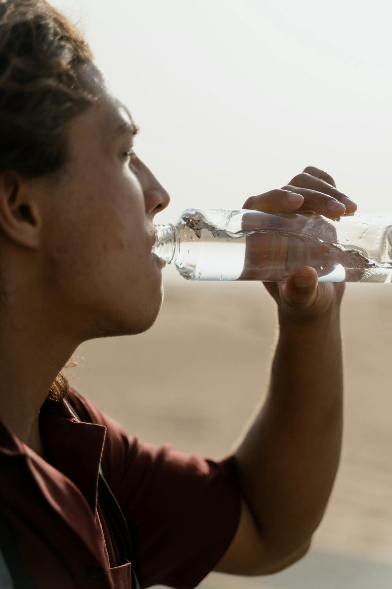 man drinks water bottle