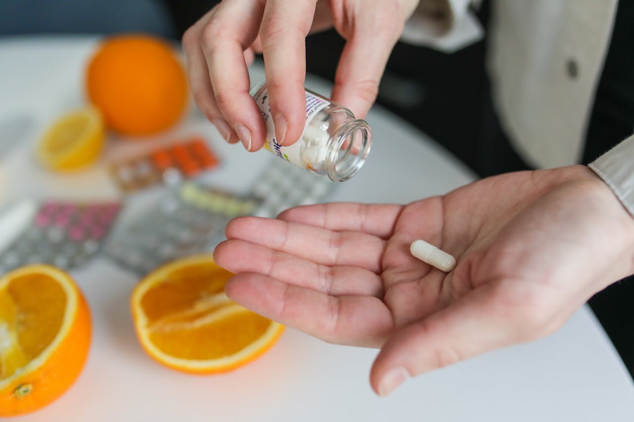 orange pill supplement hand