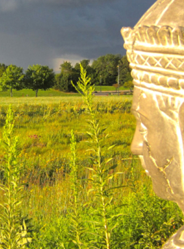 statue in a field at Perennial Yoga