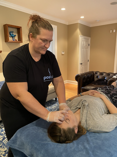 Woman receiving a jaw massage at Posture by Julie