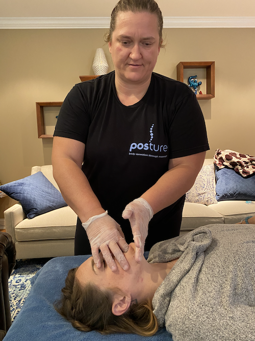TMJ Mouth Work at Posture Massage by Julie with patient laying on back on a table TMJ Mouth Work at Posture Massage by Julie with patient laying on back on a table