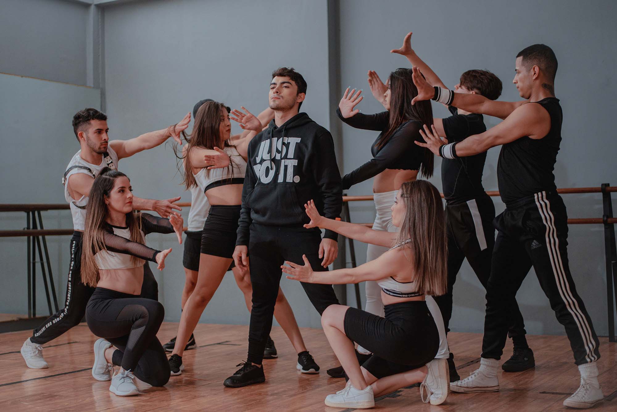 Group of dancers performing a choreographed routine with passion and precision, creating an inspiring scene of teamwork and movement in a dance studio.