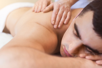 man getting a massage at red lotus yoga in rochester hills, mi