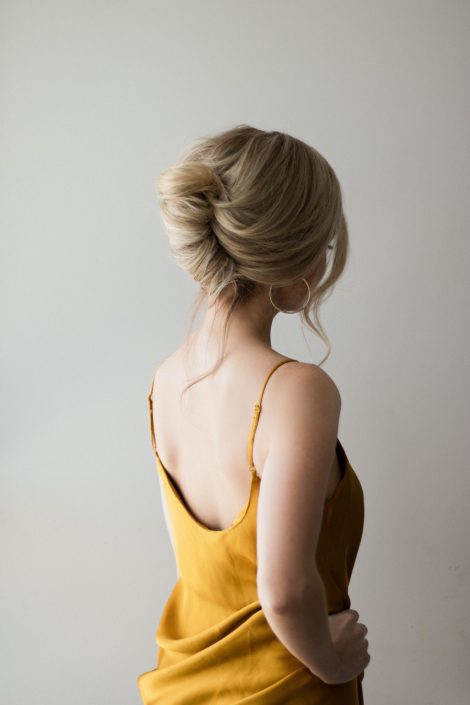 woman with high blonde french twist