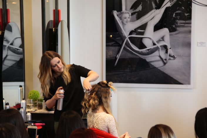 hair stylist spraying hair